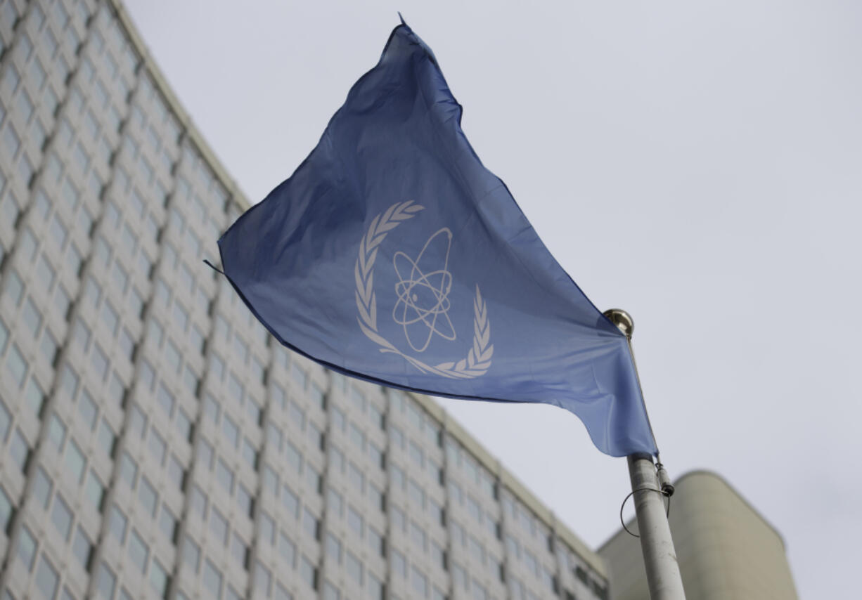 FILE - The flag of the International Atomic Energy Agency flies in front of its headquarters during an IAEA Board of Governors meeting in Vienna, Austria, on Feb. 6, 2023.