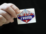 A voter displays an &ldquo;I Voted&rdquo; sticker during the first day of early voting at the Galleria at Sunset mall Saturday, Oct. 19, 2024, in Henderson, Nev.