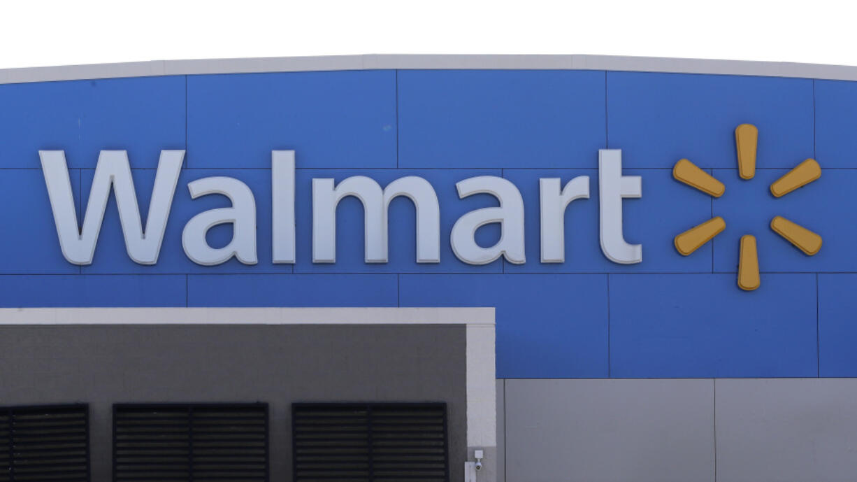 FILE - A Walmart logo is displayed outside of a Walmart store, in Walpole, Mass., Sept. 3, 2019.