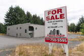 A for sale sign sits outside a vacant building on Northeast 94th Avenue in Vancouver. The building is a potential site for the city of Vancouver&rsquo;s 150-bed bridge shelter. The city passed a 0.1 percent business and occupation tax on retail to pay for the bridge shelter.