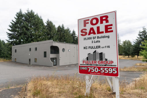 A for sale sign sits outside a vacant building on Northeast 94th Avenue in Vancouver. The building is a potential site for the city of Vancouver&rsquo;s 150-bed bridge shelter. The city passed a 0.1 percent business and occupation tax on retail to pay for the bridge shelter.