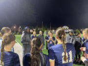 Seton Catholic girls soccer coach Antonio Buckley (left, in blue hat) talks with the Cougars postgame after a 5-0 shutout of Kiona-Benton to open the Class 1A state playoffs. Wednesday's win is the program's first-ever state playoff victory.