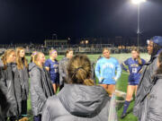 Seton Catholic girls soccer coach Antonio Buckley (right, in hat) addresses the Cougars after their 4-0 shutout of Elma in Thursday's 1A District IV winner-to-state match. The win sends Seton to Saturday's district title match.