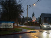 A motorist travels past York Elementary School along Northeast 152nd Avenue on Tuesday evening where Clark County will begin road construction in next summer.