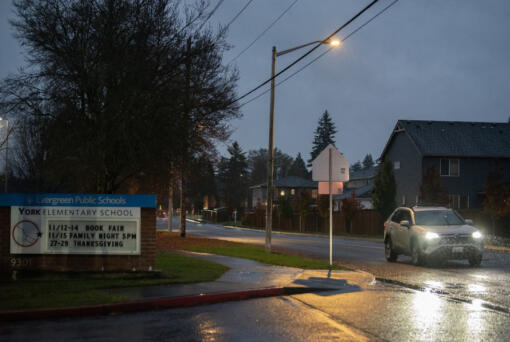 A motorist travels past York Elementary School along Northeast 152nd Avenue on Tuesday evening where Clark County will begin road construction in next summer.