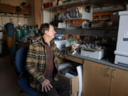 Marc Kramer of Washington State University Vancouver looks over soil samples from around the world in his campus science lab on Monday. The U.S. Forest Service and WSU Vancouver created a partnership to study wood and soil in the lab.