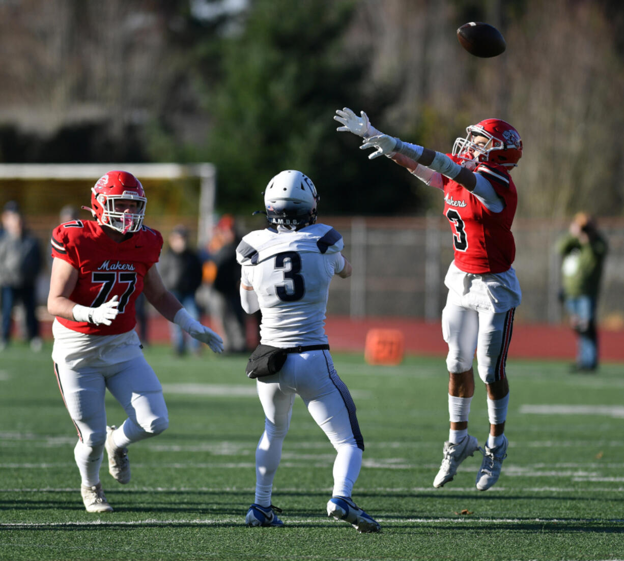 Camas senior Anthony Forner, right, knocks down a pass from Gonzaga Prep junior Sam Kincaid, center, during the Papermakers&rsquo; 28-20 win.