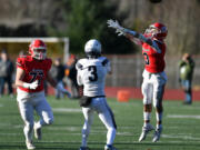 Camas senior Anthony Forner, right, knocks down a pass from Gonzaga Prep junior Sam Kincaid, center, during the Papermakers&rsquo; 28-20 win.