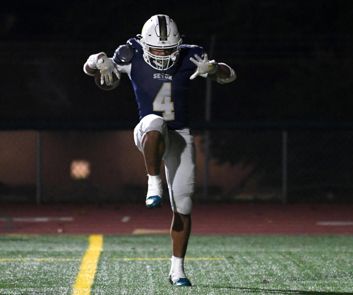 Seton Catholic&rsquo;s Jacob Williams (4) celebrates after scoring a touchdown during the Cougars&rsquo; win against Montesano.