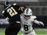 Seton Catholic senior Garrett Nebels (8) forces a fumble from Royal’s Jackson Larsen (21) on Friday, Dec. 6, 2024, during Seton’s 61-28 loss to Royal in the WIAA 1A State Football Championship at Husky Stadium in Seattle.