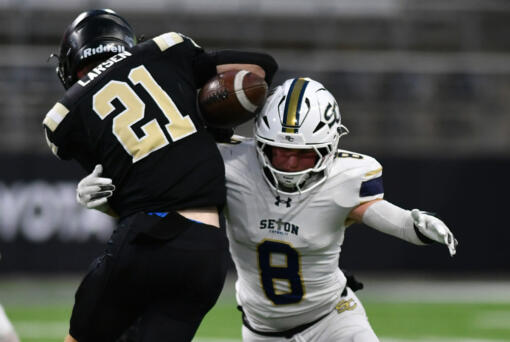 Seton Catholic senior Garrett Nebels (8) forces a fumble from Royal’s Jackson Larsen (21) on Friday, Dec. 6, 2024, during Seton’s 61-28 loss to Royal in the WIAA 1A State Football Championship at Husky Stadium in Seattle.