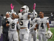 Seton Catholic senior Ryker Ruelas (5) pumps up the crowd after a touchdown Friday, Dec. 6, 2024, during Seton’s 61-28 loss to Royal in the WIAA 1A State Football Championship at Husky Stadium in Seattle.