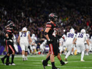 Camas senior Nikko Speer, center, and other teammates walk off the field as Sumner celebrates their game-winning field goal Saturday, Dec. 7, 2024, after the Papermakers’ 27-24 loss to Sumner in the 4A State Championship game at Husky Stadium.