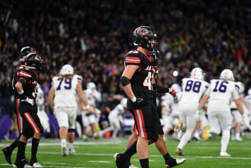 Camas senior Nikko Speer, center, and other teammates walk off the field as Sumner celebrates their game-winning field goal Saturday, Dec. 7, 2024, after the Papermakers’ 27-24 loss to Sumner in the 4A State Championship game at Husky Stadium.