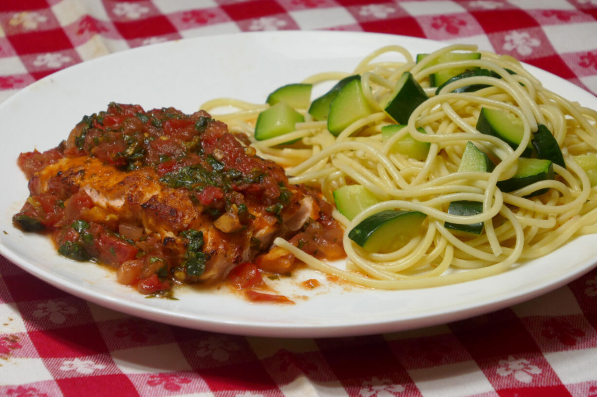 Tomato Basil Sauced Salmon served with a side of Zucchini With Spaghetti and Parmesan.