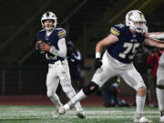 Seton Catholic junior Kolten Gesser (13) drops back to pass Saturday, Nov. 30, 2024, during Seton Catholic&iacute;s win against Montesano in the 1A semifinals at McKenzie Stadium.