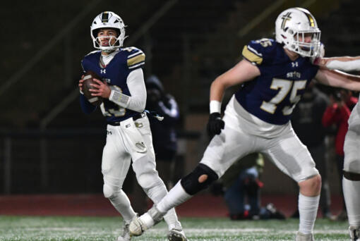 Seton Catholic junior Kolten Gesser (13) drops back to pass Saturday, Nov. 30, 2024, during Seton Catholic&iacute;s win against Montesano in the 1A semifinals at McKenzie Stadium.