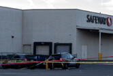 Law enforcement officers investigate a shooting at the Cascade Park Safeway store on Dec. 5. Vancouver police shot and killed a man the night before after he physically attacked a police officer, according to a statement from the agency.