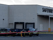 Law enforcement officers investigate a shooting at the Cascade Park Safeway store on Dec. 5. Vancouver police shot and killed a man the night before after he physically attacked a police officer, according to a statement from the agency.