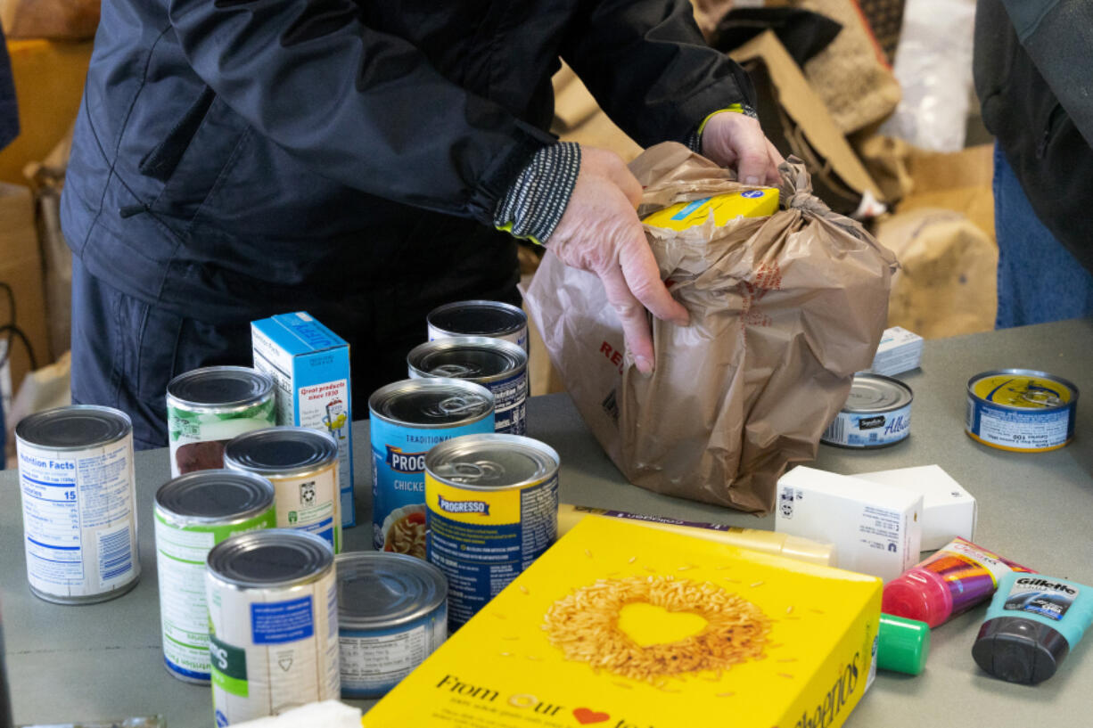 Volunteers sort through food donated by residents in Vancouver in December 2022.