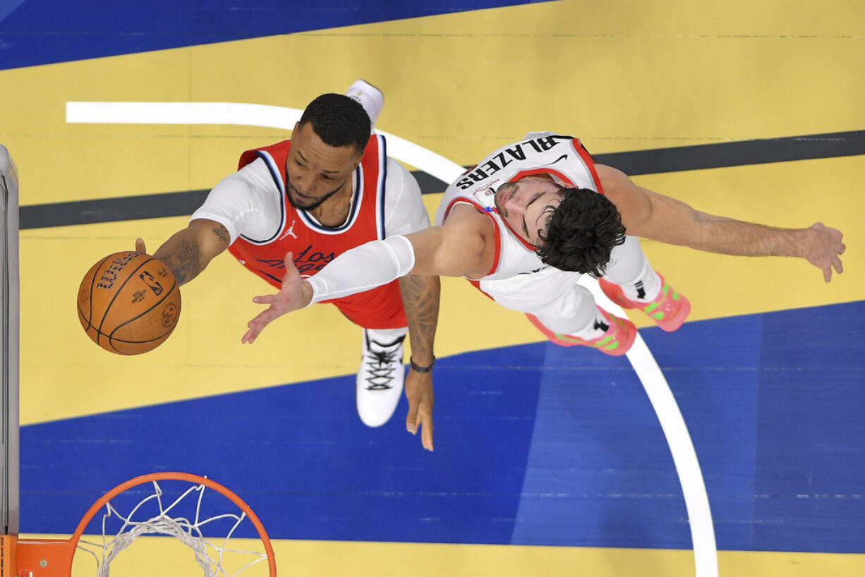 Los Angeles Clippers guard Norman Powell, left, shoots as Portland Trail Blazers forward Deni Avdija defends during the first half of an Emirates NBA Cup basketball game, Tuesday, Dec. 3, 2024, in Inglewood, Calif. (AP Photo/Mark J.