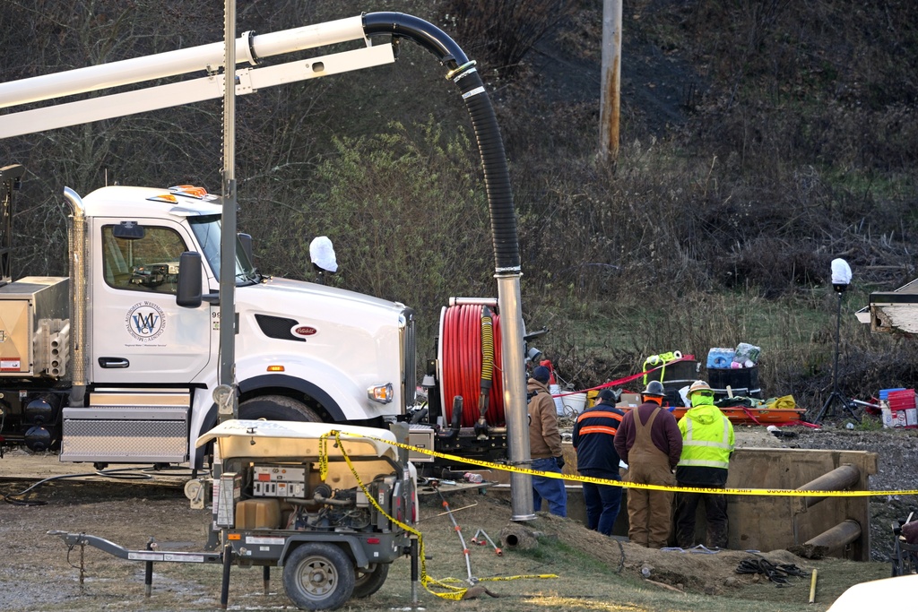 Rescue workers continue to search, Wednesday, Dec. 4, 2024, for Elizabeth Pollard, who is believed to have disappeared in a sinkhole while looking for her cat, in Marguerite, Pa. (AP Photo/Gene J.