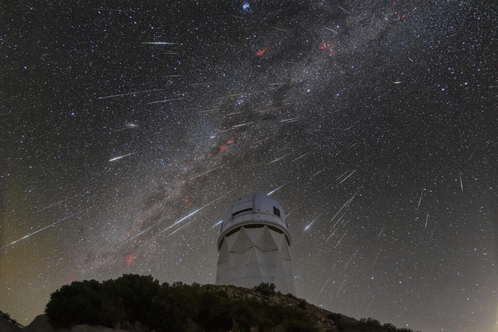 FILE - In this Dec. 14, 2023 photo provided by NOIRLab, meteors from the Geminid meteor shower streak across the sky above the Nicholas U. Mayall Telescope at Kitt Peak National Observatory (KPNO), a program of the National Science Foundation's NOIRLab, located about 56 miles (90 kilometers) southwest of Tucson in the Tohono O'odham Nation.