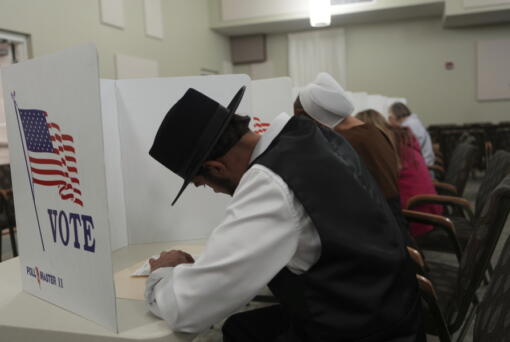 Members of the Amish community, Samuel Stoltzfus and his wife Lillian Stoltzfus, vote at a polling center at the Garden Spot Village retirement community in New Holland, Pa., Tuesday, Nov. 5, 2024.