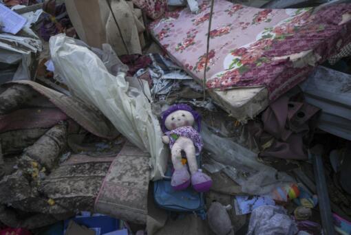 A doll lies among plastic debris and clothes in the aftermath of an Israeli airstrike at the Muwassi camp near Khan Younis, in the southern Gaza Strip, on Thursday, Dec. 5, 2024. Israeli airstrikes struck the camp for displaced Palestinians in southern Gaza on Wednesday, killing at least 21 people, according to the head of a nearby hospital.