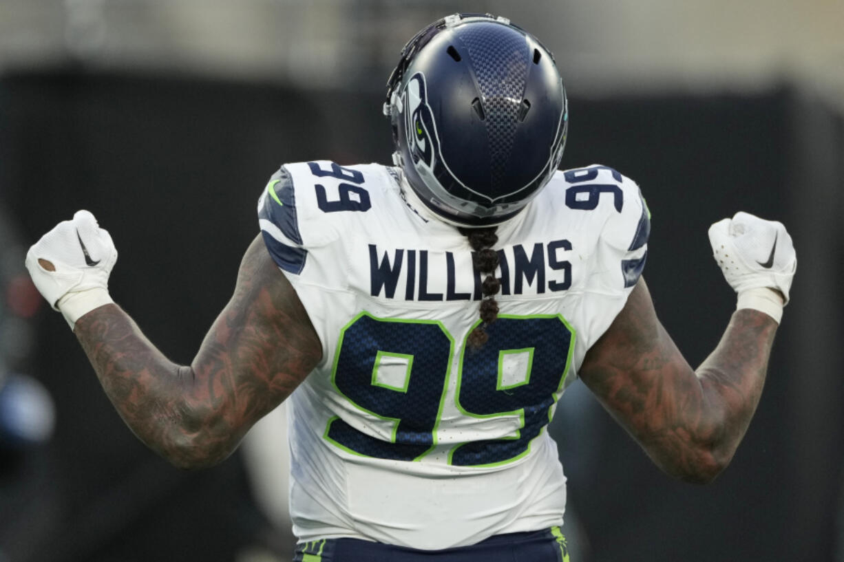 Seattle Seahawks defensive end Leonard Williams (99) reacts after sacking New York Jets quarterback Aaron Rodgers during the fourth quarter of an NFL football game, Sunday, Dec. 1, 2024, in East Rutherford, N.J.