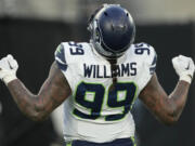 Seattle Seahawks defensive end Leonard Williams (99) reacts after sacking New York Jets quarterback Aaron Rodgers during the fourth quarter of an NFL football game, Sunday, Dec. 1, 2024, in East Rutherford, N.J.