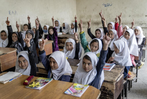 FILE -FILE - Afghan school girls attend their classroom on the first day of the new school year, in Kabul, Saturday, March 25, 2023.