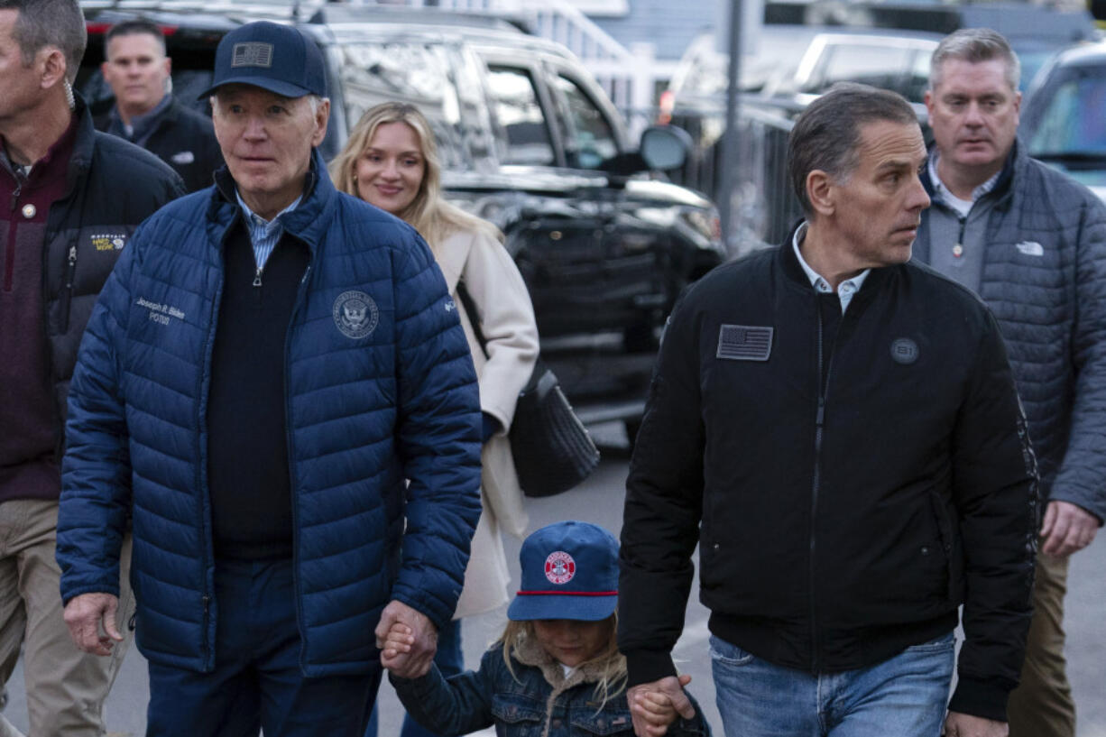 President Joe Biden with his son Hunter Biden and his grandson Beau walk in downtown Nantucket Mass., Friday, Nov. 29, 2024.