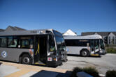 Two C-Tran buses are pictured near Clark College in Vancouver. The transit agency passed its 2025 and 2026 budgets Tuesday night.