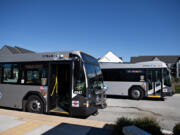 Two C-Tran buses are pictured near Clark College in Vancouver. The transit agency passed its 2025 and 2026 budgets Tuesday night.