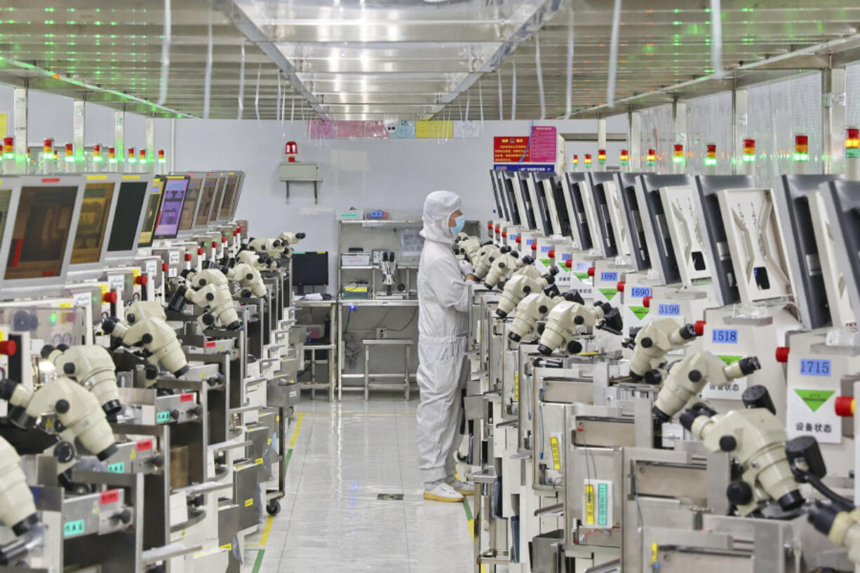 FILE - A man works at a manufacturer of Integrated Chip encapsulation in Nantong in eastern China&rsquo;s Jiangsu province on Friday, Sept. 16, 2022.