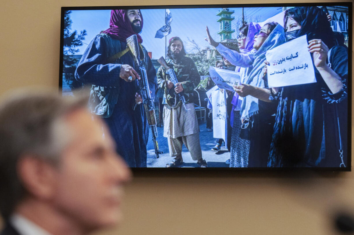 Secretary of State Antony Blinken speaks as a photograph from Afghanistan is seen on a television screen Wednesday during a House Committee on Foreign Affairs hearing on the U.S. withdrawal from Afghanistan on Capitol Hill.