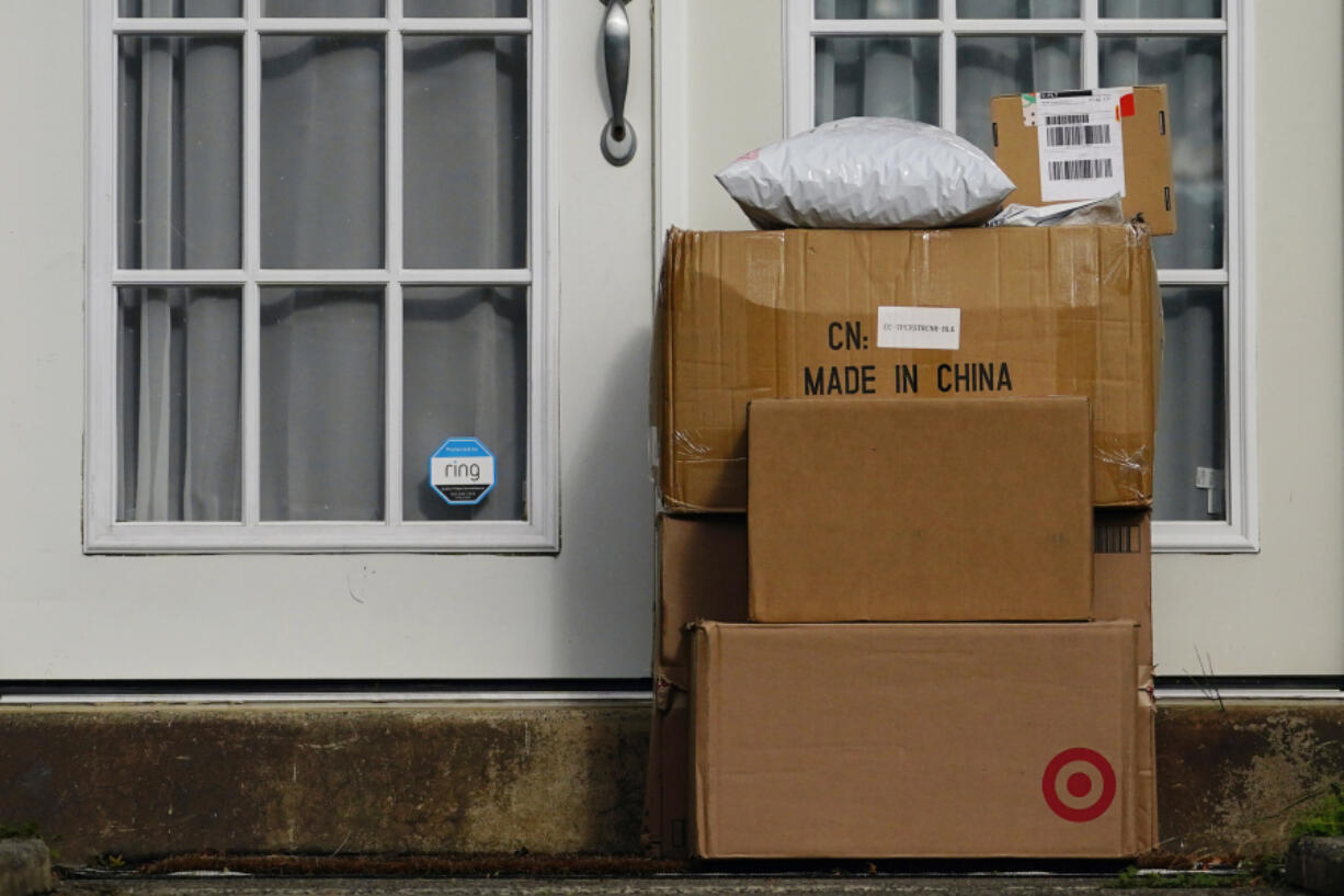 FILE - Packages are seen stacked on the doorstep of a residence, Oct. 27, 2021, in Upper Darby, Pa.