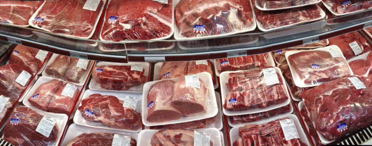 FILE - In this Nov. 2, 2013 file photo, various cuts of beef and pork are displayed for sale in the meat department at a discount market in Arlington, Va. (AP Photo/J.