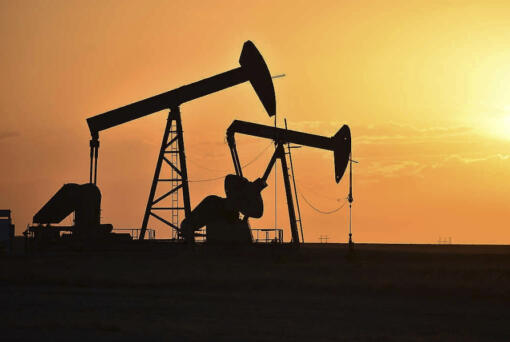 FILE - Pump jacks extract oil from beneath the ground in North Dakota, May 19, 2021.