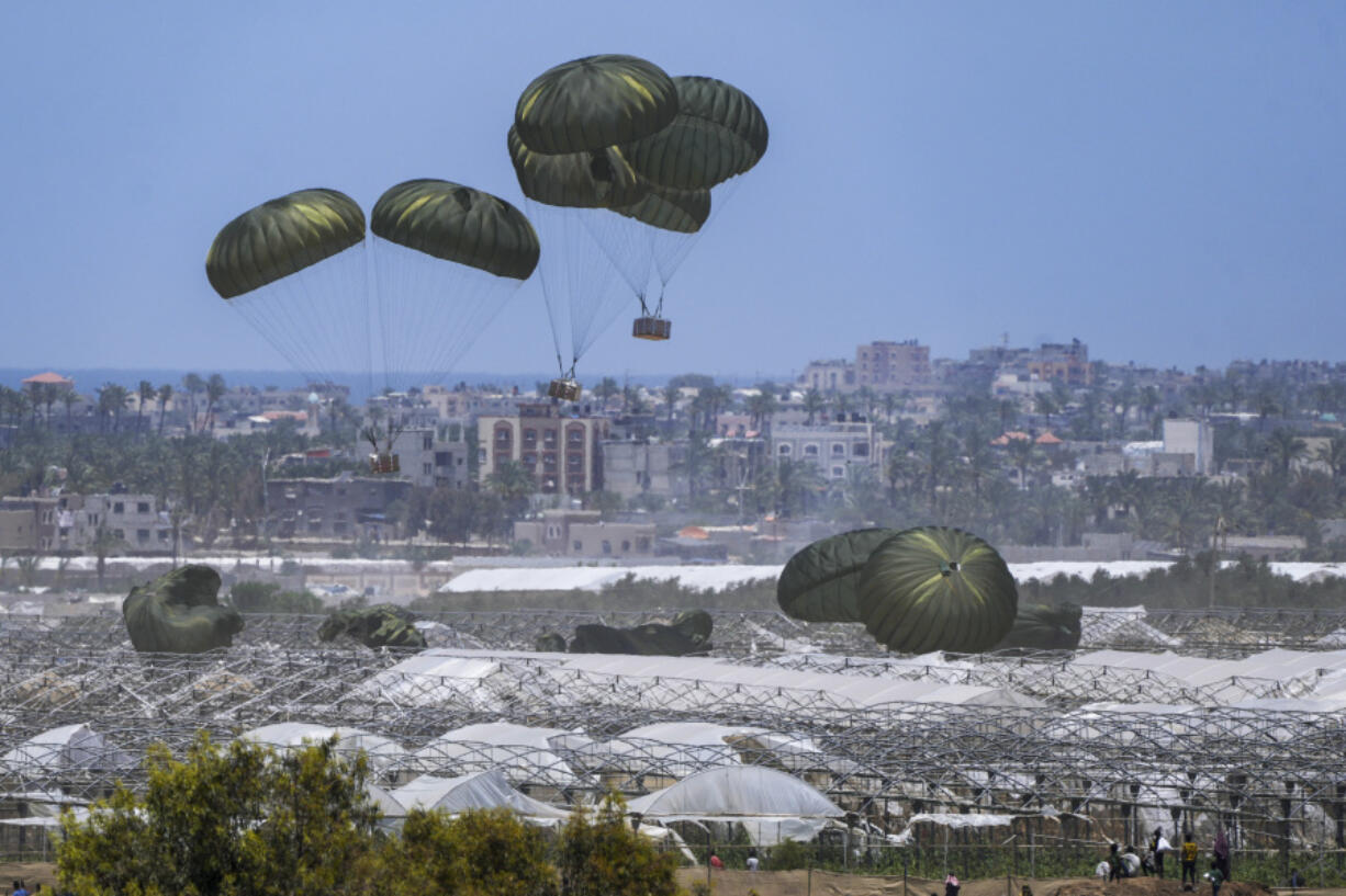 FILE - An aircraft airdrops humanitarian aid over Khan Younis, Gaza Strip, May 30, 2024.