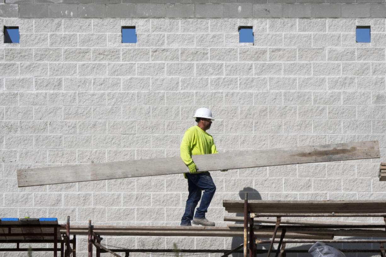 FILE - A construction worker walks on scaffolding at a building site on Sept. 4, 2024, in Waukee, Iowa.