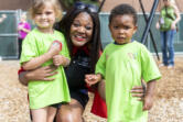 Educational Opportunities for Children and Families CEO Rekah Strong poses for a photo with students Maycee Hawn, left, and Jameson Owens during a field day at Educational Opportunities for Children and Families on MacArthur Boulevard in July 2023.