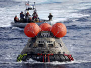 NASA&rsquo;s Orion capsule is drawn to the well deck of the USS Portland after it splashed down following a successful uncrewed Artemis I moon mission, in the Pacific Ocean off the coast of Baja California, Mexico, Dec. 11, 2022.