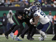 Seattle Seahawks defensive end Leonard Williams (99) sacks New York Jets quarterback Aaron Rodgers (8).