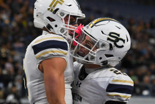 Ryker Ruelas (left) of Seton Catholic celebrates with Teddy Wieczorek after scoring a touchdowns against Royal in the 1A state championship game at Husky Stadium in Seattle on Friday, Dec. 6, 2024.